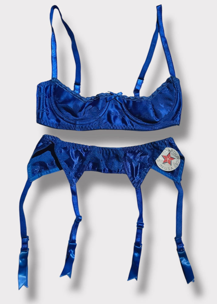 Blue lingerie set with star detail on a light gray background