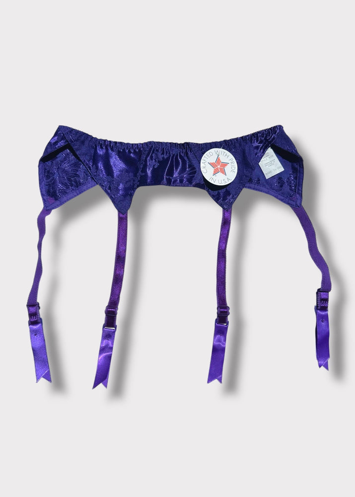 Purple satin garter belt with a star design on a light gray background