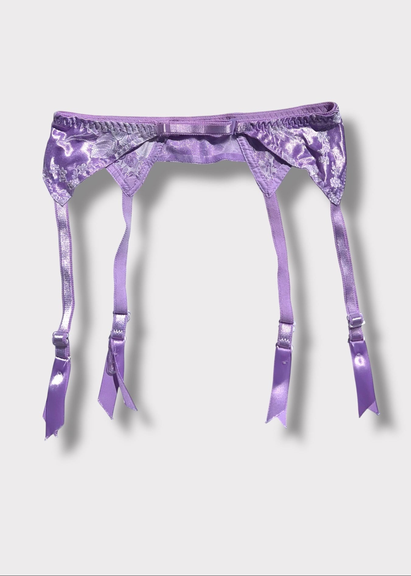 Purple satin garter belt on a white background