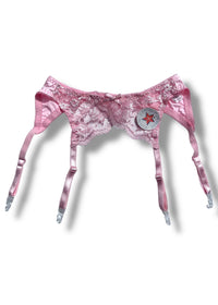 Pink lace lingerie set on a white background