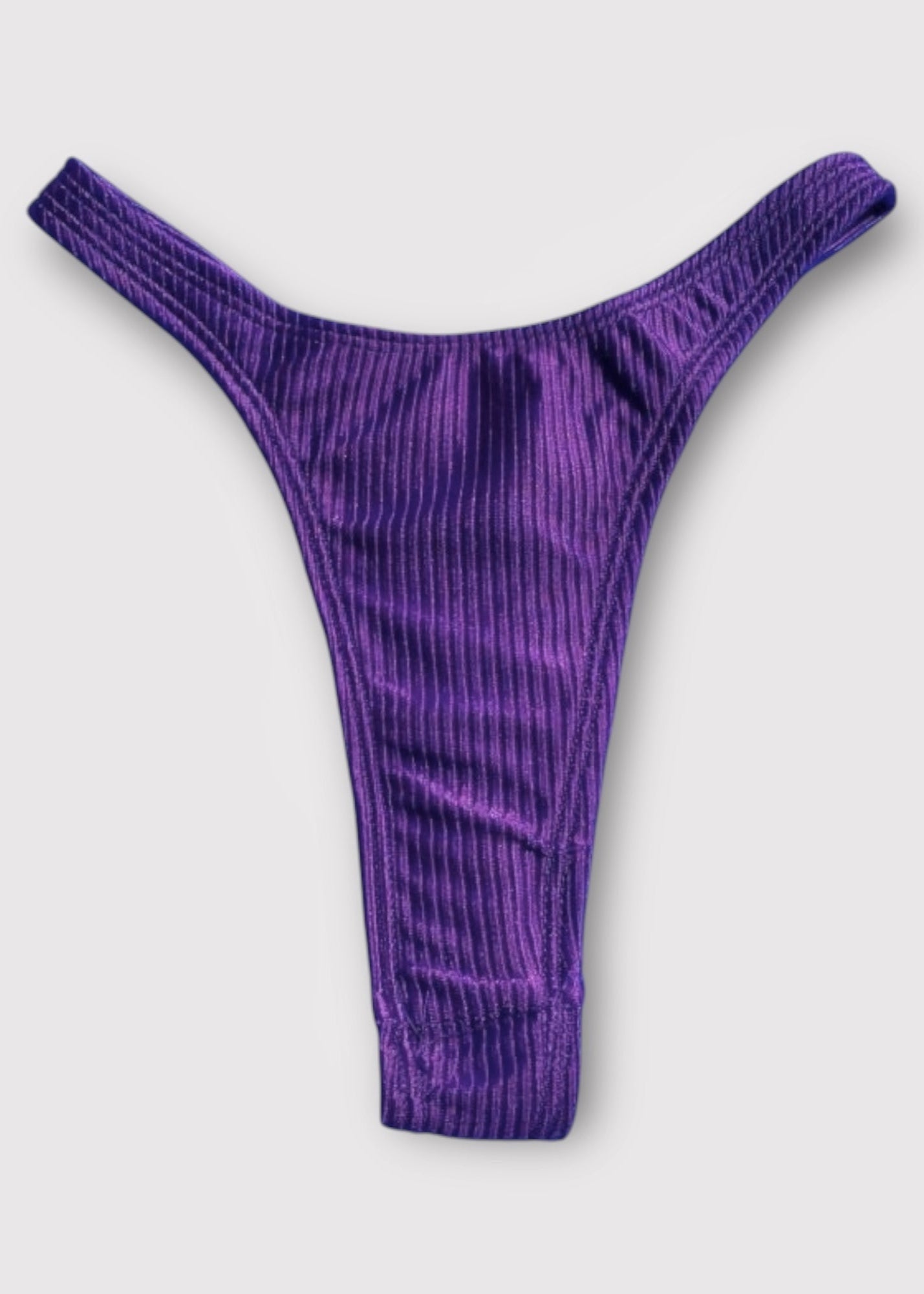 Purple ribbed thong on a light gray background