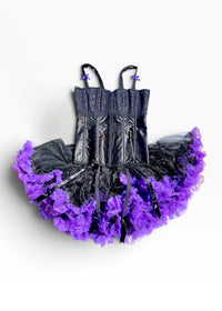 A gothic-style tutu dress featuring a black lace corset bodice with thin straps and a layered ruffled tutu skirt in black and vibrant purple, shown against a plain white background.