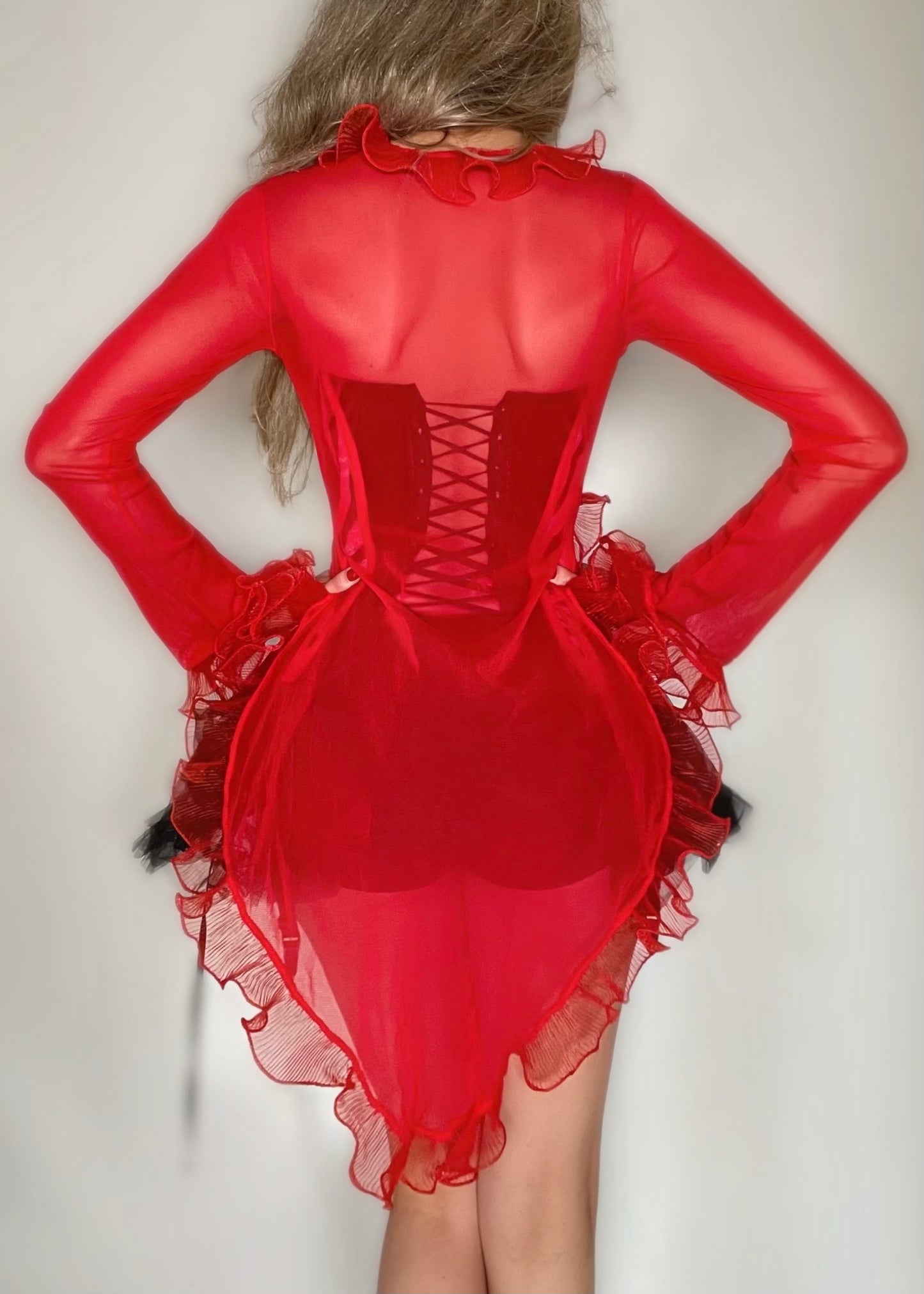 Red sheer dress with lace-up back on a plain background