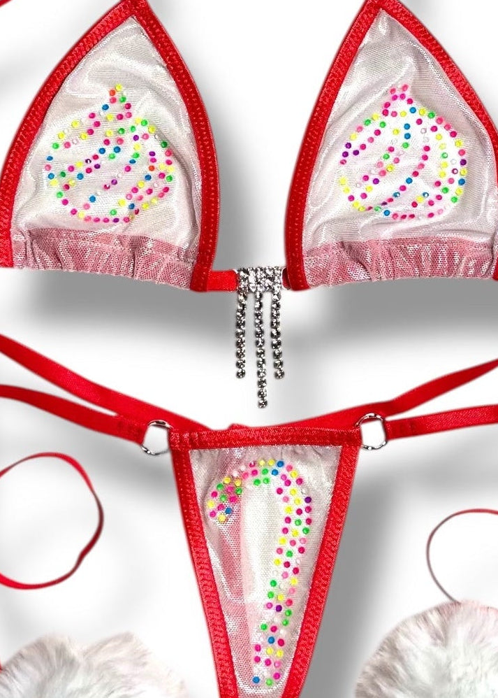 Red bikini set with white pom-poms on a white background