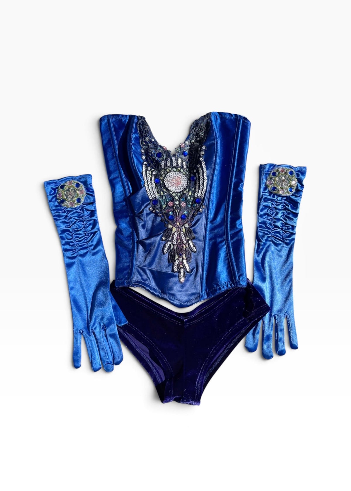 A royal blue velvet costume set featuring a bodysuit with a large silver and blue feather embellishment, matching long gloves with feather details, and matching high-waisted briefs, laid flat on a white background.