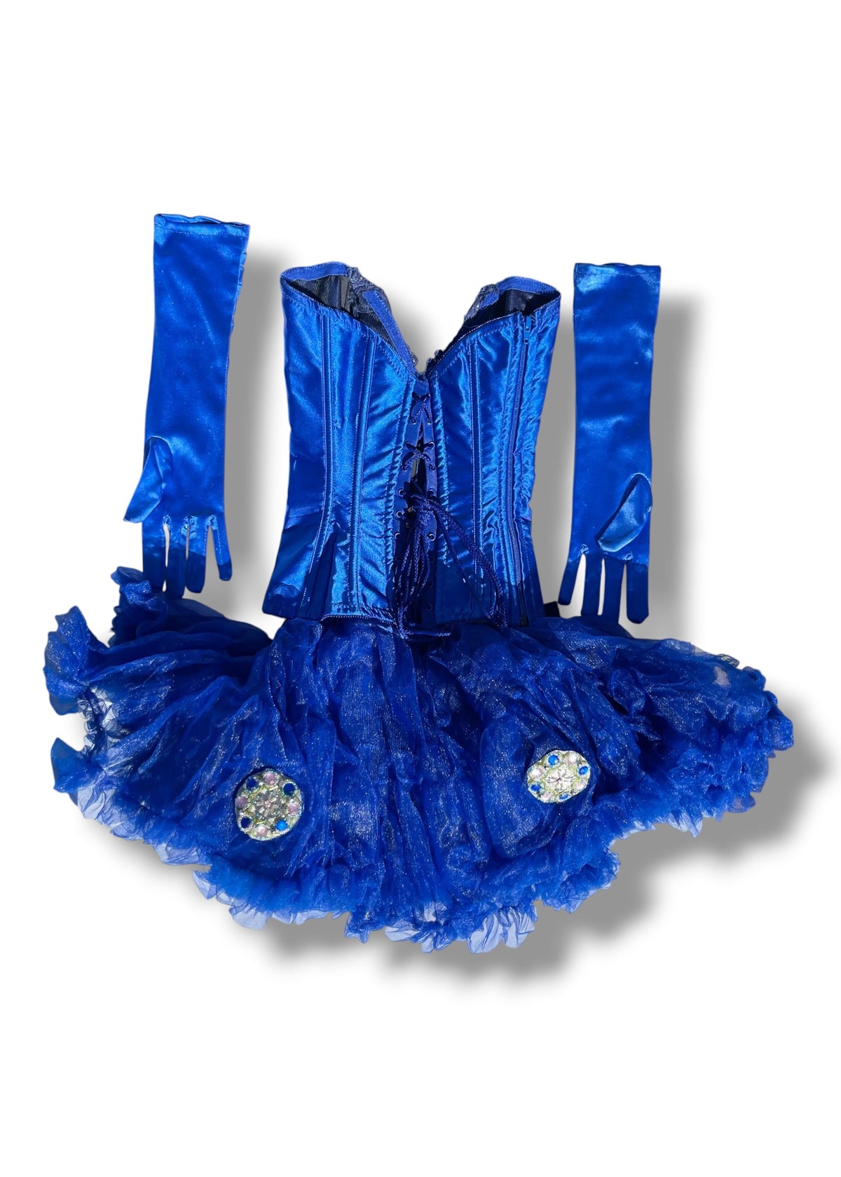 A royal blue costume set featuring a corset-style top, a ruffled tutu skirt with two rhinestone embellishments, and matching long satin gloves, displayed on a white background.