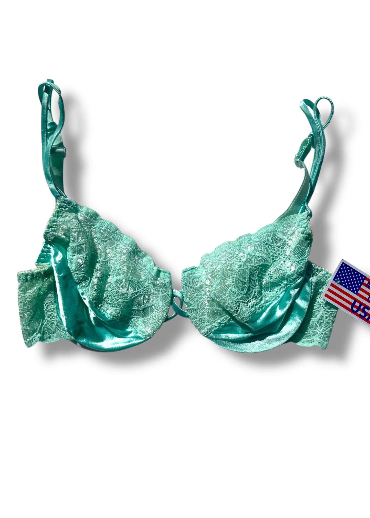 Green bra with lace details on a white background