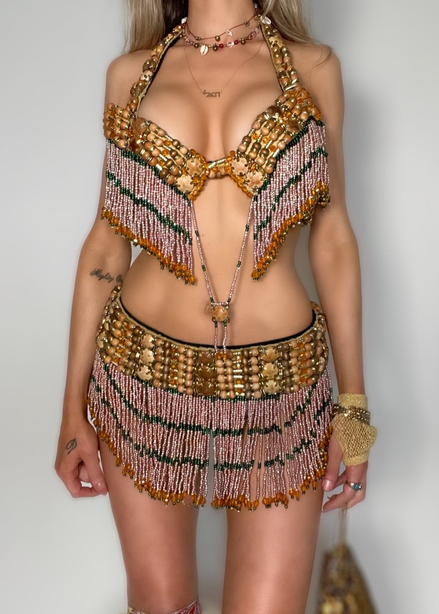 A vintage 1990&#39;s handmade boho princess beaded bra and mini skirt set with wooden and glass beads in earthy tones.