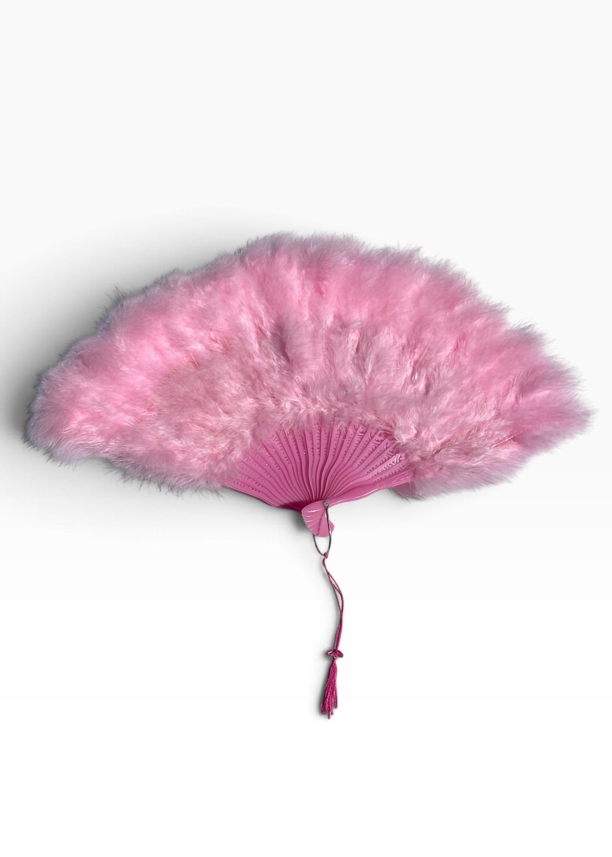 A pink feather fan with a matching pink fabric handle and tassel, displayed against a clean white background.