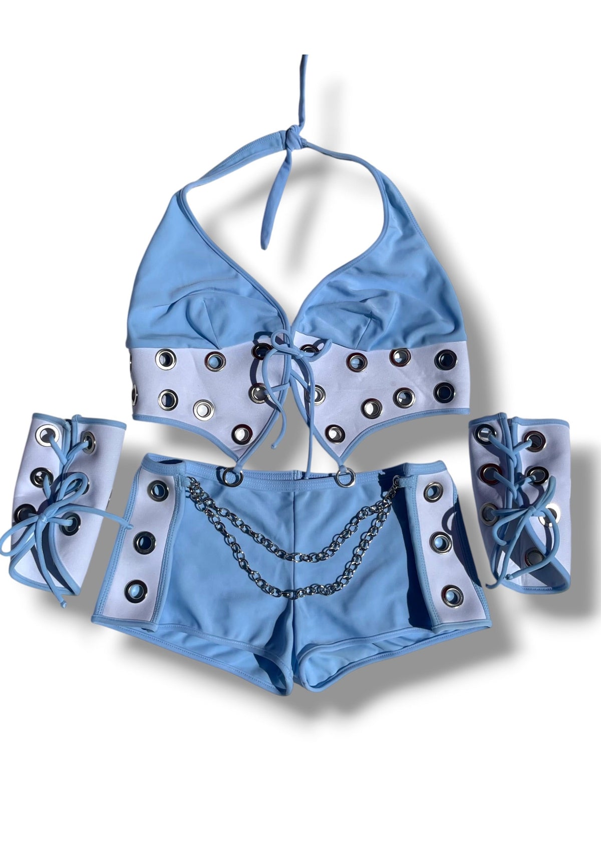 A light blue and white two-piece costume set with silver metal grommets, a silver chain detail, and matching white arm warmers with blue lace-up ties, displayed on a white background.