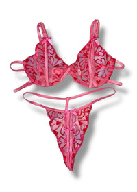 Pink bikini set with floral patterns on a white background