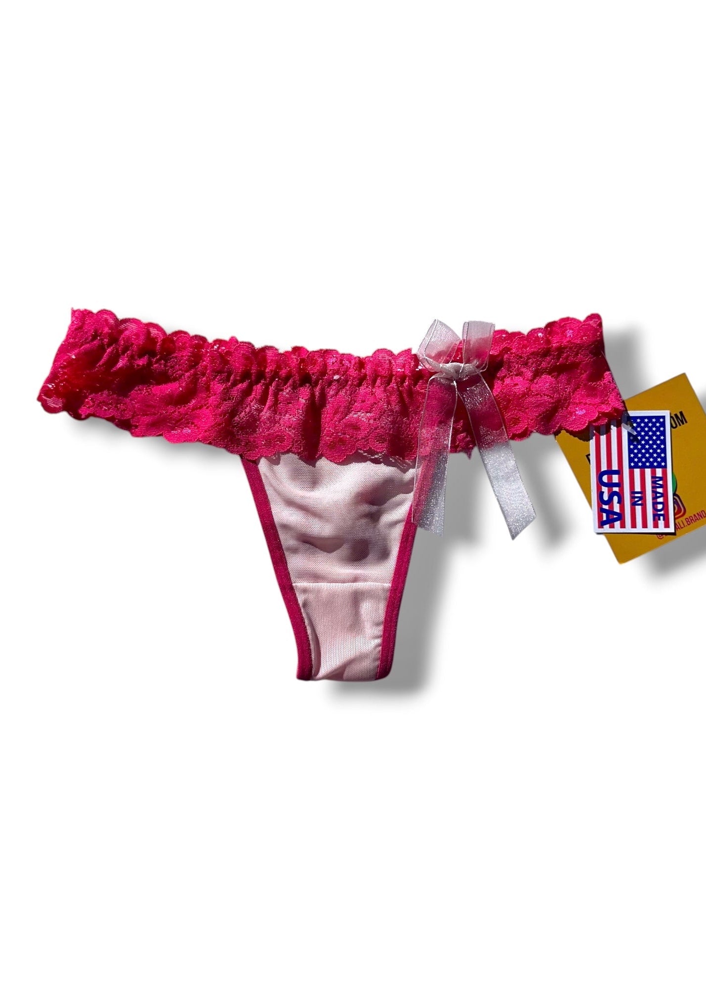 Pink and white lace thong with a tag on a white background
