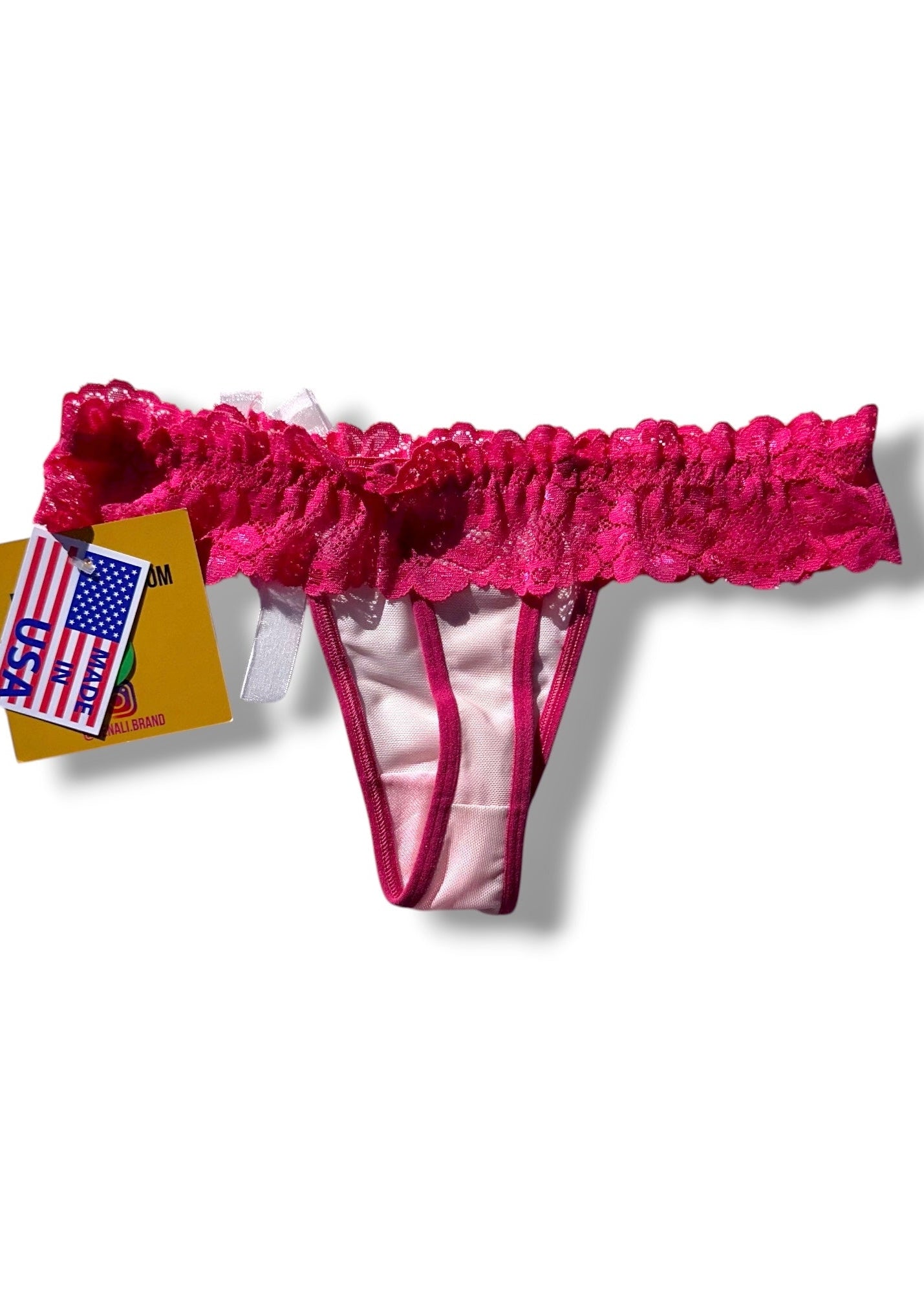 Pink lace thong with a matching garter belt on a white background