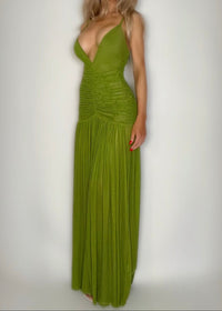 Woman wearing a green evening gown against a white background