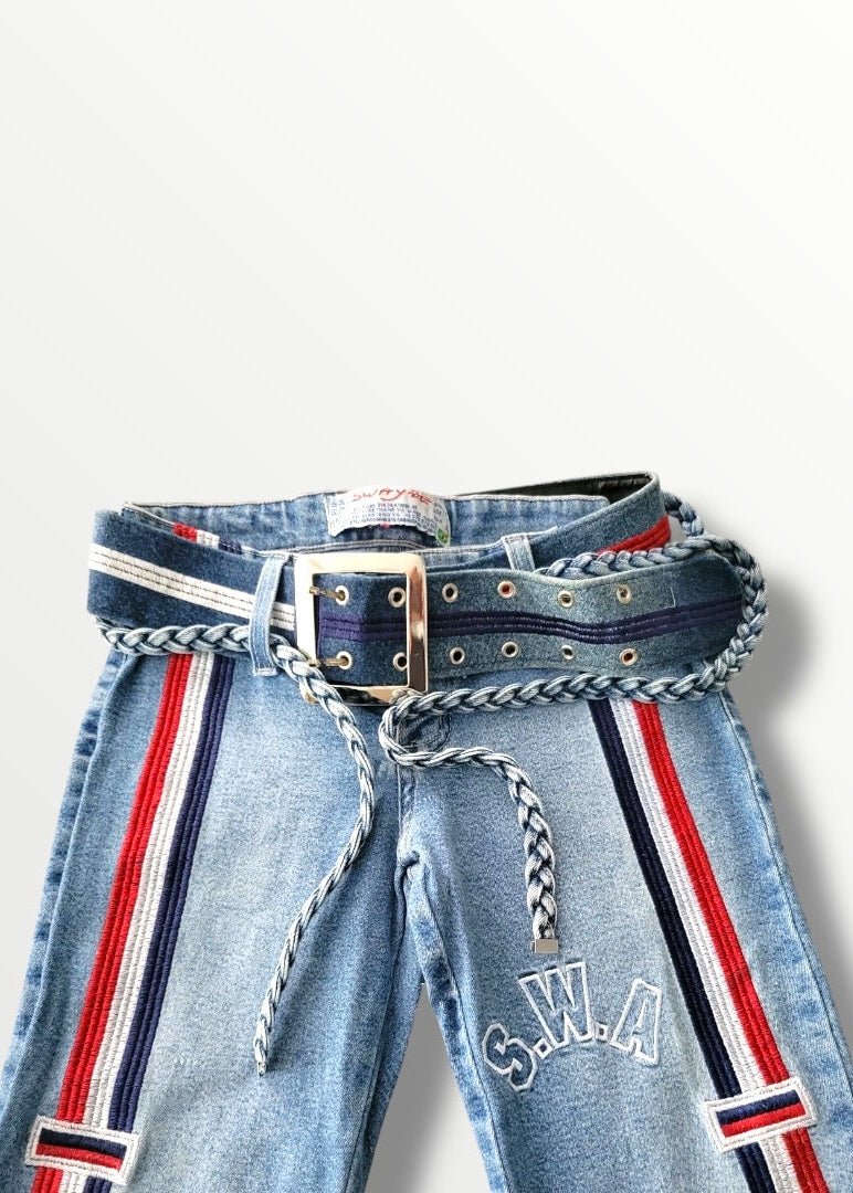 Light blue jeans with red and navy striped belt and 'S.W.A.' branding on a white background