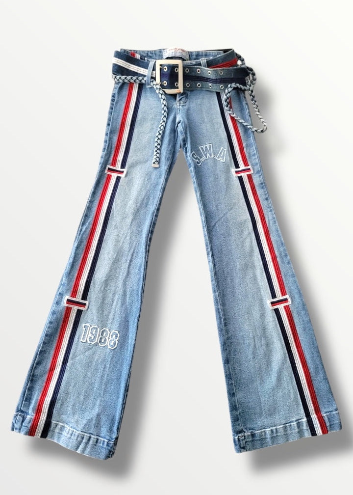 Light blue jeans with red and black striped belt on a white background