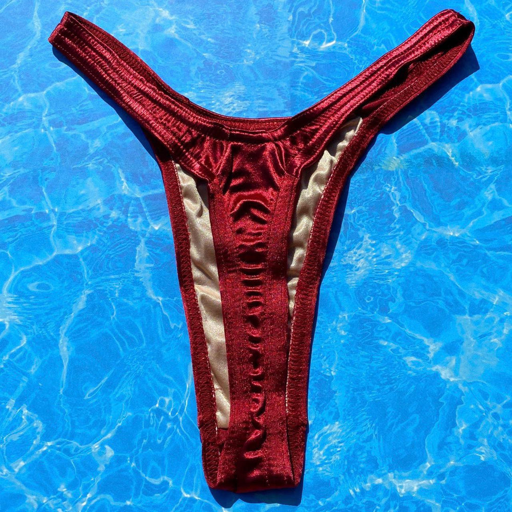 
                      
                        Satin Shimmer Ultra Flattering Thong Bikini Bottom | Cranberry
                      
                    